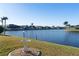 Landscaped backyard with canal view and bird bath at 716 Monaco Dr, Punta Gorda, FL 33950