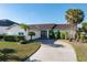 Single-story home with a tile roof, landscaped yard, and driveway at 716 Monaco Dr, Punta Gorda, FL 33950