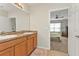 Well-lit bathroom with double sinks and a doorway leading to the main bedroom at 7325 Mikasa Dr, Punta Gorda, FL 33950