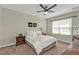 Comfortable bedroom with a ceiling fan, window with blinds, and a serene decor at 7325 Mikasa Dr, Punta Gorda, FL 33950