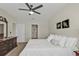 Comfortable bedroom with a ceiling fan, ensuite bathroom, window with blinds, and classic furniture at 7325 Mikasa Dr, Punta Gorda, FL 33950