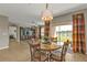 Bright dining area with a glass table, decorative chandelier, and sliding glass doors overlooking the water at 7325 Mikasa Dr, Punta Gorda, FL 33950