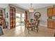 Bright dining area with a glass table, decorative chandelier, and sliding glass doors to the lanai at 7325 Mikasa Dr, Punta Gorda, FL 33950