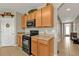 Spacious kitchen featuring wooden cabinets, black appliances, and ample counter space at 7325 Mikasa Dr, Punta Gorda, FL 33950