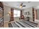 Inviting living room with a ceiling fan, striped rug, and comfortable seating at 7325 Mikasa Dr, Punta Gorda, FL 33950