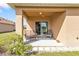 Covered patio includes chairs and a view through the sliding glass doors at 7325 Mikasa Dr, Punta Gorda, FL 33950