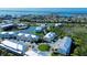 Aerial shot of the community showcasing its end-unit condo, waterfront setting, and beautifully landscaped grounds at 10311 Lands End Cir # 16, Placida, FL 33946