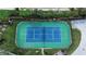 Overhead shot of a well maintained tennis court surrounded by lush landscaping at 10311 Lands End Cir # 16, Placida, FL 33946
