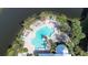 Aerial view of the community pool with palm trees and lounge chairs at 10311 Lands End Cir # 16, Placida, FL 33946