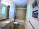 Bright bathroom featuring a granite vanity top, a tub-shower with tile surround, and charming coastal decor at 10311 Lands End Cir # 16, Placida, FL 33946