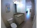Bathroom with granite vanity top; door opens to living area with sofa in the distance at 10311 Lands End Cir # 16, Placida, FL 33946