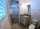 Bathroom with granite vanity leading into a bedroom at 10311 Lands End Cir # 16, Placida, FL 33946