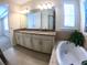 Bathroom boasts double granite vanity, soaking tub, and shuttered windows at 10311 Lands End Cir # 16, Placida, FL 33946