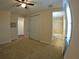 Spacious bedroom with a closet, ceiling fan, and access to the bathroom at 10311 Lands End Cir # 16, Placida, FL 33946