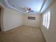 Spacious carpeted bedroom with plantation shutters and tray ceiling with ceiling fan at 10311 Lands End Cir # 16, Placida, FL 33946
