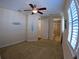 Spacious bedroom features carpet, ceiling fan, and an attached bathroom at 10311 Lands End Cir # 16, Placida, FL 33946