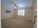 Spacious carpeted bedroom with plantation shutters and tray ceiling with ceiling fan at 10311 Lands End Cir # 16, Placida, FL 33946