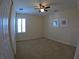 Bedroom features carpet flooring, ceiling fan, and shuttered windows at 10311 Lands End Cir # 16, Placida, FL 33946