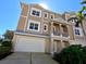 Beautiful front exterior of the condo building showcasing the two-car garage and large windows at 10311 Lands End Cir # 16, Placida, FL 33946