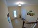 Second floor foyer with view of downstairs entrance, tiled floor, and beach decor at 10311 Lands End Cir # 16, Placida, FL 33946