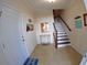 Welcoming foyer with tiled floor, staircase, and beach-themed decor for a coastal touch at 10311 Lands End Cir # 16, Placida, FL 33946