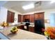 A charming kitchen with dark wood cabinets, a breakfast bar, and modern appliances at 10311 Lands End Cir # 16, Placida, FL 33946