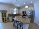 A spacious kitchen with stainless steel appliances, granite countertops, white cabinetry, tile backsplash and flooring at 10311 Lands End Cir # 16, Placida, FL 33946