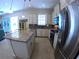 Bright kitchen featuring white cabinets, granite counters, stainless steel appliances, and a spacious island at 10311 Lands End Cir # 16, Placida, FL 33946