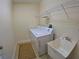 Well-lit laundry room with large capacity washer and dryer plus a utility sink and wire shelving at 10311 Lands End Cir # 16, Placida, FL 33946