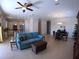 Comfortable living room showcasing a blue sofa, a dining area, and a view into the kitchen at 10311 Lands End Cir # 16, Placida, FL 33946