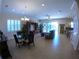 Expansive living area showcasing tile flooring, a dining space, and views towards the kitchen and outdoor balcony at 10311 Lands End Cir # 16, Placida, FL 33946
