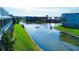 Scenic view of the community pond and surrounding buildings, offering a peaceful and serene atmosphere with lush greenery at 10311 Lands End Cir # 16, Placida, FL 33946