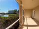 Covered and screened outdoor porch providing an outdoor living space with a view of the pond at 10311 Lands End Cir # 16, Placida, FL 33946