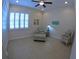 Sitting room with tile floors, ceiling fan, white trim, and comfortable chairs at 10311 Lands End Cir # 16, Placida, FL 33946