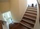 Carpeted staircase with wood treads and white risers, leading to the dining area at 10311 Lands End Cir # 16, Placida, FL 33946