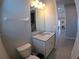 Cozy powder room with a marble-topped vanity, neutral walls, and chrome fixtures at 10421 Coral Landings Ln # 107, Placida, FL 33946