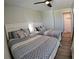 Bright guest bedroom with hardwood floors, ceiling fan, and two well-made twin beds at 10421 Coral Landings Ln # 107, Placida, FL 33946