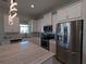 Modern kitchen featuring white cabinets, stainless steel appliances, and stylish pendant lighting at 10421 Coral Landings Ln # 107, Placida, FL 33946