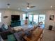 Comfortable living room with contemporary furnishings, leading out to a screened lanai with scenic views at 10421 Coral Landings Ln # 107, Placida, FL 33946