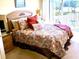 Comfortable main bedroom with a decorative bed and access to a private balcony at 1186 Rio De Janeiro Ave # 106, Punta Gorda, FL 33983