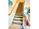 Carpeted staircase ascending to the upper level of the home with an open view at 1186 Rio De Janeiro Ave # 106, Punta Gorda, FL 33983