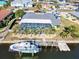 Aerial view of beautiful pool, outdoor lanai, boat dock and lift in a waterfront community at 121 Sinclair Se St, Port Charlotte, FL 33952