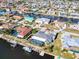 Aerial view of a waterfront community with many boat docks, pools, and well maintained lawns at 121 Sinclair Se St, Port Charlotte, FL 33952