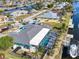 Aerial view of single-Gathering home with large RV, screened-in pool, and private boat dock on canal at 121 Sinclair Se St, Port Charlotte, FL 33952