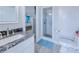 Bathroom with granite vanity top, glass-enclosed shower, and tile floors at 121 Sinclair Se St, Port Charlotte, FL 33952