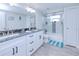 Bathroom featuring double sinks, a glass-enclosed shower, modern finishes, and ample lighting at 121 Sinclair Se St, Port Charlotte, FL 33952