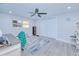 Bedroom with ceiling fan, window, and gray wood-look floors at 121 Sinclair Se St, Port Charlotte, FL 33952