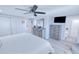 Bright bedroom with a ceiling fan, wood-look floors, and gray wood furniture at 121 Sinclair Se St, Port Charlotte, FL 33952