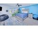 Bedroom with blue accent wall, ceiling fan, and gray wood flooring at 121 Sinclair Se St, Port Charlotte, FL 33952