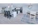 Dining area near the kitchen with bar seating, a modern table, and stylish decor at 121 Sinclair Se St, Port Charlotte, FL 33952